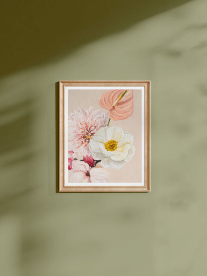 Pastel flower print framed in natural wood hanging on a green wall