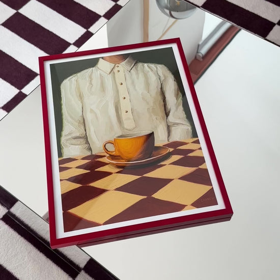 Art print of the original oil painting “A Cup of Quiet” that captures a moment of everyday life. This artwork showcases a woman dressed in a silk shirt, seated peacefully in front of an orange cup of coffee, placed on a checkered table. "A Cup of Quiet" is a window into an ordinary moment of life, frozen in time. Let this artwork serve as a daily invitation to pause, reflect, and relish in the quietude of life.