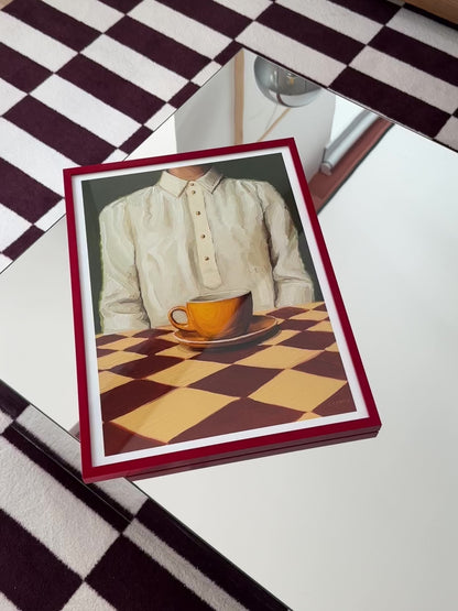 Art print of the original oil painting “A Cup of Quiet” that captures a moment of everyday life. This artwork showcases a woman dressed in a silk shirt, seated peacefully in front of an orange cup of coffee, placed on a checkered table. "A Cup of Quiet" is a window into an ordinary moment of life, frozen in time. Let this artwork serve as a daily invitation to pause, reflect, and relish in the quietude of life.